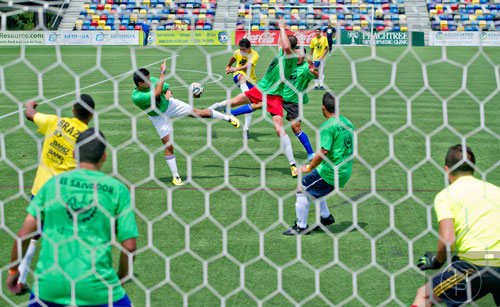 Thiago DeFaria (center) tries to kick the ball past defenders as Brazil takes on El Salvador during the Atlanta International Soccer Fest at the Atlanta Silverbacks' soccer complex on Saturday, June 7, 2014. 