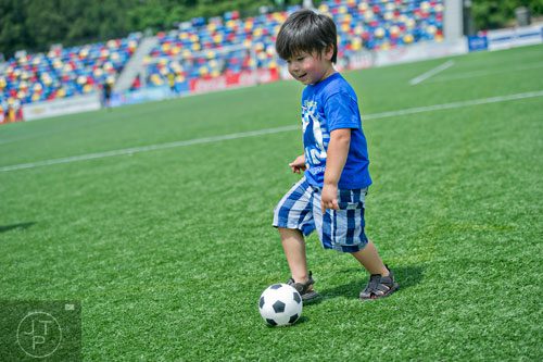 Jaime Carrizales Jr. kicks a miniature soccer ball around the field during the Atlanta International Soccer Fest at the Atlanta Silverbacks' soccer complex on Saturday, June 7, 2014. 