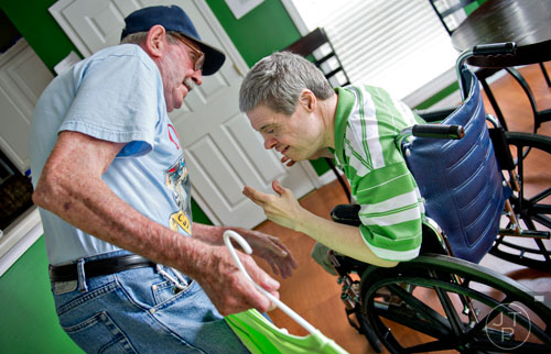 Alvin McGarity (left) leans down to say hello to his son Keith at the Southern Community Living Group home in McDonough on Sunday, June 15, 2014. 