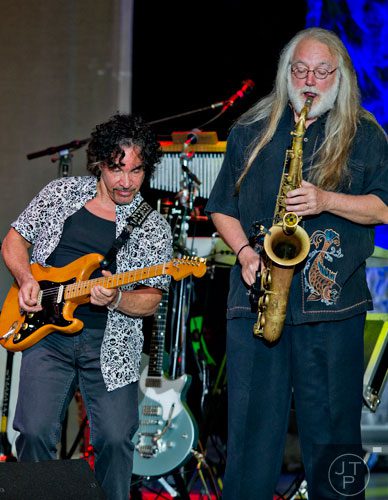 John Oates (left) plays side by side with saxophonist Charlie DeChant on stage at Chastain Park Amphitheatre in Atlanta on Sunday, June 15, 2014.  