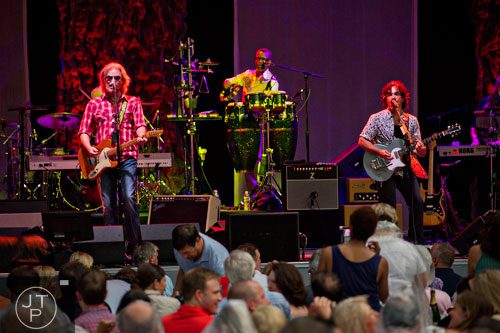 Daryl Hall (left) and John Oates perform on stage at Chastain Park Amphitheatre in Atlanta on Sunday, June 15, 2014.  