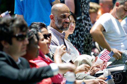 Muhamed Alfargani (right) waits to become a naturalized citizen of the United States during the World Refugee Day celebration at the Clarkston Community Center in Clarkston on Saturday, June 21, 2014. 