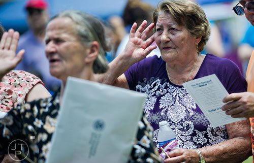 Roslia Trimino (right) takes an oath to become a naturalized citizen of the United States during the World Refugee Day celebration at the Clarkston Community Center in Clarkston on Saturday, June 21, 2014. 