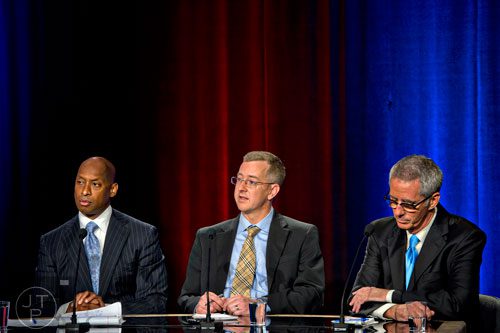 Panelists Christopher King (left), Jeremy Redmon and Doug Richards pose questions to candidates from the 10th and 11th Congressional districts during the Atlanta Press Club's Loudermilk- Young Debate Series at the Georgia Public Broadcasting studios in Atlanta on Sunday, July, 13, 2014.  