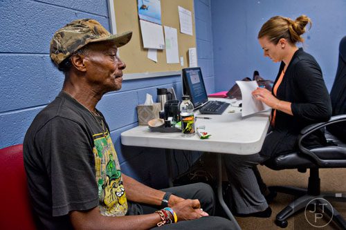 Gregory McKinney (left) answers questions from Jolene Glenn as she helps him fill out the proper forms to start receiving food assistance at the Central Outreach & Advocacy Center in Atlanta on Tuesday, July 22, 2014.