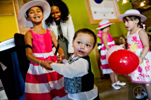 Bounkham Phonesavanh (center) dances with his oldest sister Emma during a farewell breakfast at Delightful Eatz in Atlanta on Wednesday, July 2, 2014. 