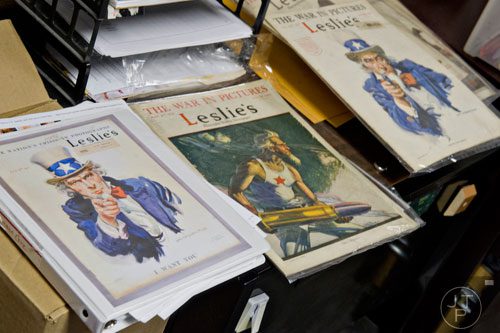 Copies of Leslie's Illustrated Weekly Newspaper sit in Steve Ehrlich's office in Marietta as he explains how the covers were created from 1917-1918 to garner support for World War I on Wednesday, July 2, 2014. 