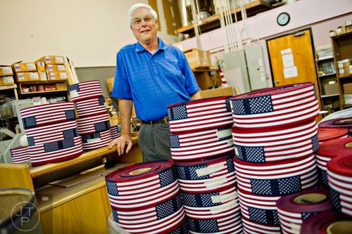 Steve Ehrlich stands surrounded by American flag fabric at his business, U.S. Flag Makers, in Marietta on Wednesday, July 2, 2014. 