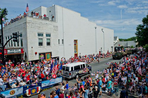 The Marietta Freedom Parade makes its way past the Strand Theatre and through Historic Marietta Square on Friday, July 4, 2014. 