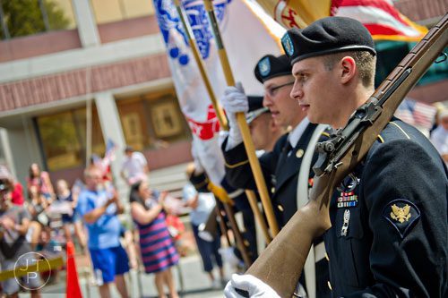 Spc. Logan Rees carries his rifle as he marches through Historic Marietta Square during the city's  Freedom Parade on Friday, July 4, 2014. 