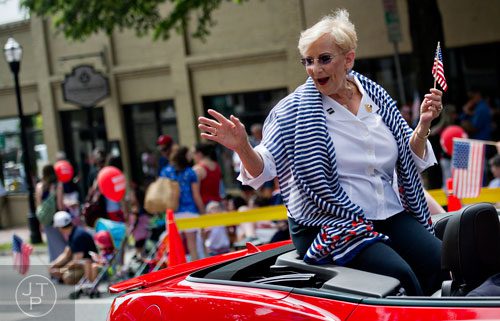 Sandra Deal waves to the crowd as she rides in a convertible towards Historic Marietta Square during the city's  Freedom Parade on Friday, July 4, 2014. 