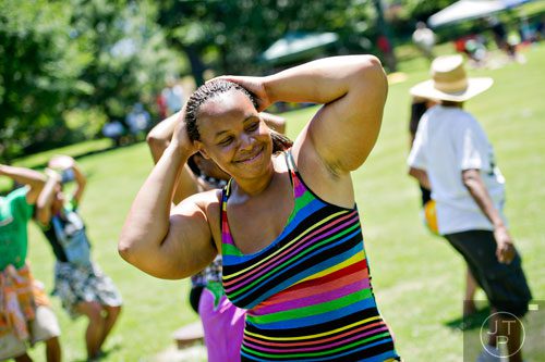 Edna Jeffries (center) learns to hula dance during the Nezian Festival at Grant Park in Atlanta on Saturday, July 5, 2014. 