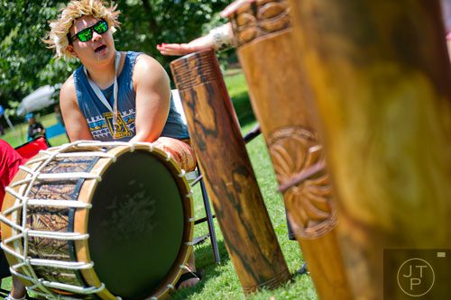 Kela Fisher bangs on a drum as he performs with his family during the Nezian Festival at Grant Park in Atlanta on Saturday, July 5, 2014. 