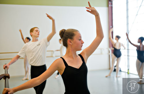 Anna Scott Johnson (center) and Brennan Parker practice different ballet positions during summer camp at the Atlanta Ballet's Michael C. Carlos Dance Centre in Atlanta on Tuesday, July 8, 2014.  