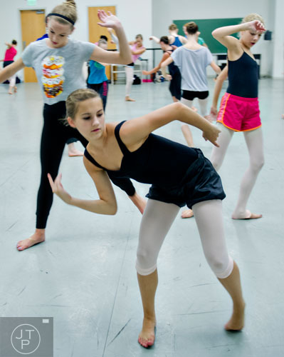 Sydney Twardos (center) moves across the floor during a contemporary dance class for summer camp at the Atlanta Ballet's Michael C. Carlos Dance Centre in Atlanta on Tuesday, July 8, 2014.   