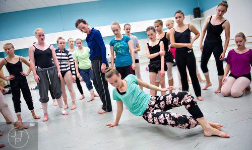Rebecca Craig (bottom) uses her hands and feet to move around the floor as other campers watch during a contemporary dance class for summer camp at the Atlanta Ballet's Michael C. Carlos Dance Centre in Atlanta on Tuesday, July 8, 2014.   