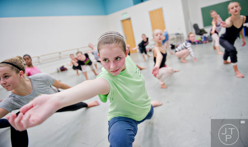 Emma Millhollin (center) moves across the floor during a contemporary dance class for summer camp at the Atlanta Ballet's Michael C. Carlos Dance Centre in Atlanta on Tuesday, July 8, 2014.  