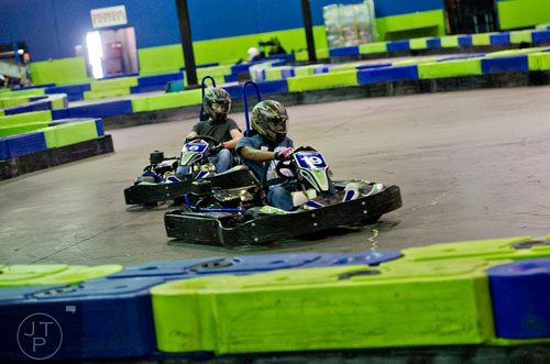 J'Mel Marcus (19) tries to keep his lead over Byron Sullivan as they race around the track during the Pro Cup Karting summer camp in Roswell on Wednesday, July 9, 2014.  