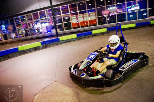 Johnny O'Neill flies around the track in a go kart during the Pro Cup Karting summer camp in Roswell on Wednesday, July 9, 2014.  