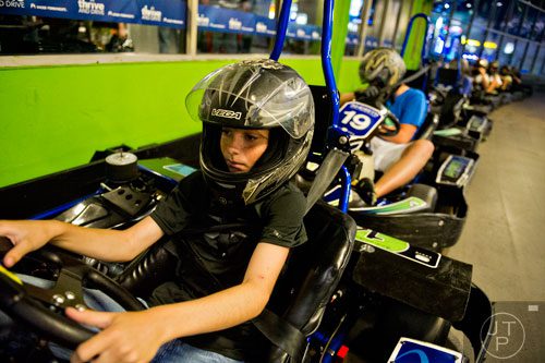 Corbin Sullivan checks his steering wheel response before starting a race circuit during the Pro Cup Karting summer camp in Roswell on Wednesday, July 9, 2014. 