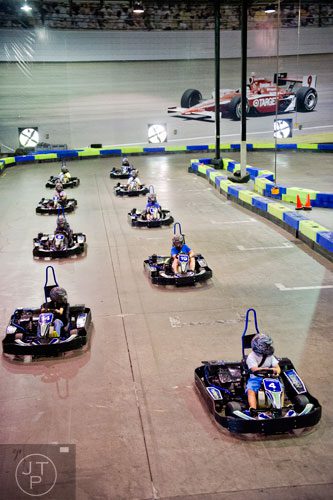 Campers line up to start a race circuit during the Pro Cup Karting summer camp in Roswell on Wednesday, July 9, 2014.  