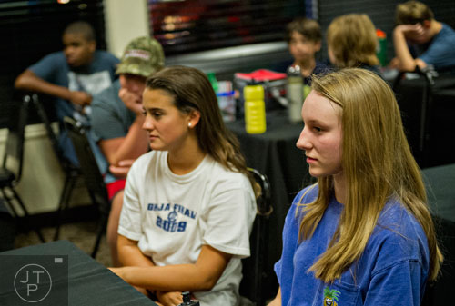 Josie Hyden (right) and Ali Vanderslice sit through a review session during the Pro Cup Karting summer camp in Roswell on Wednesday, July 9, 2014.  