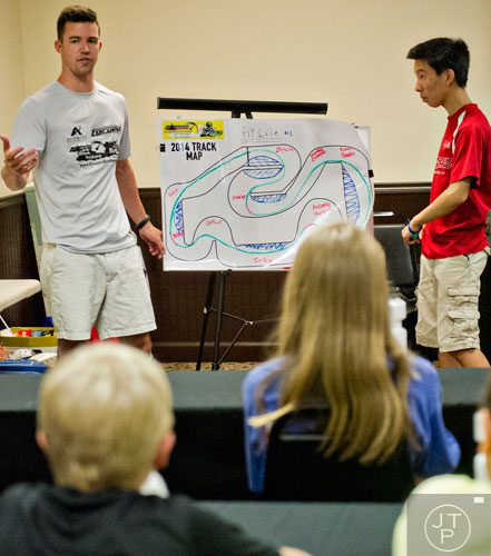 Patrick Wilmot (left) and Kelvin Xiang review the track layout with their campers during the Pro Cup Karting summer camp in Roswell on Wednesday, July 9, 2014.  