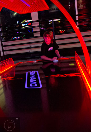 Dylan Whitlock plays a game of air hockey during the Pro Cup Karting summer camp in Roswell on Wednesday, July 9, 2014.  