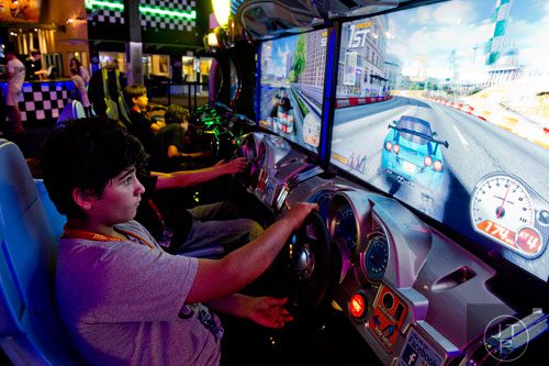 Ourand Nikoui practices his racing skills off the course as he plays a video game during the Pro Cup Karting summer camp in Roswell on Wednesday, July 9, 2014.  