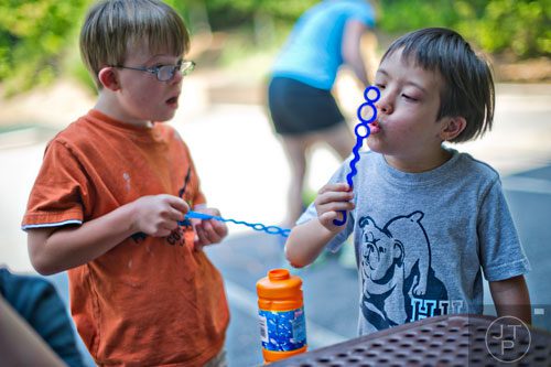 William Lynch (right) and Micah Stantonl play with bubbles during Camp Happy Hearts in Alpharetta on Tuesday, June 17, 2014. 