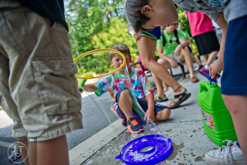 William Lynch (right) and Ethan Campbell play with bubbles during Camp Happy Hearts in Alpharetta on Tuesday, June 17, 2014. 