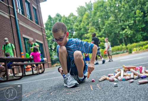 Chance Bailey plays with chalk during Camp Happy Hearts in Alpharetta on Tuesday, June 17, 2014. 