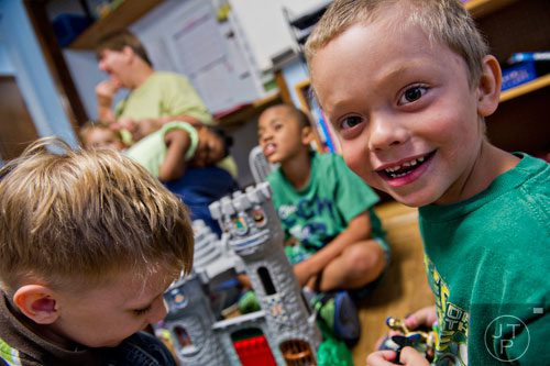 Caden Bell (right) plays with other campers during Mad Scientist Week at the Special Needs Schools of Gwinnett Summer Enrichment Camp in Lawrenceville on Wednesday, June 18, 2014. 