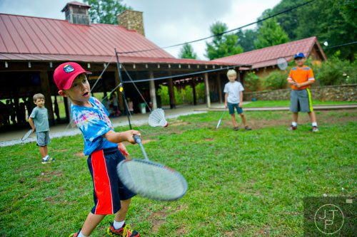 Liam Kotheimer (center) plays a game of badminton with Jake Smith, Nicholas Sanders and his brother Aidan during Camp Serenbe in Chattahoochee Hills on Tuesday, July 15, 2014.  
