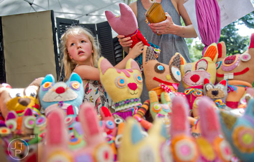 Clementine Boyer (left) hands a stuffed animal to her mother Monika at one of the artist booths during the Grant Park Summer Shade Festival in Atlanta on Saturday, August 23, 2014. 