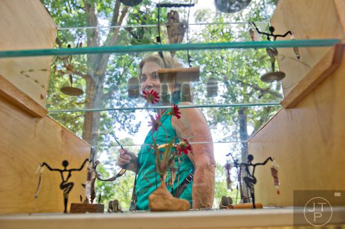 Rickie Charvat looks at jewelry as she passes by one of the artist booths during the Grant Park Summer Shade Festival in Atlanta on Saturday, August 23, 2014.