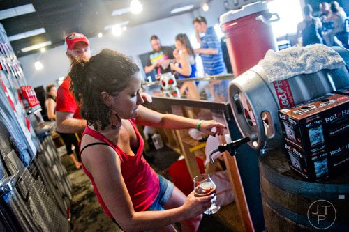 Erica Honeycutt pours beer into a glass at Red Hare Brewery in Marietta during the company's third anniversary party on Saturday, August 23, 2014.