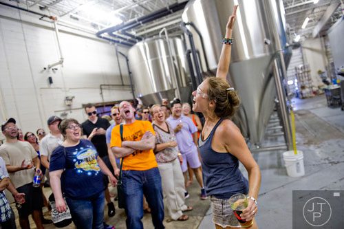 Bri Brock (right) leads a tour at Red Hare Brewery in Marietta during the company's third anniversary party on Saturday, August 23, 2014.