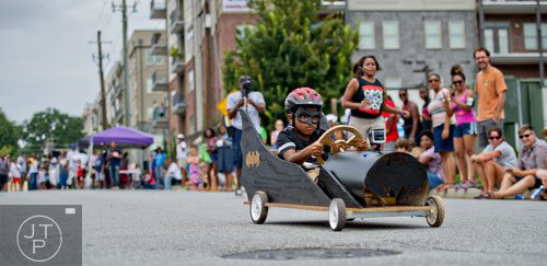 Chase Harris steers his car down the street during the 2nd annual Cool Dads Rock Soap Box Derby at Historic Fourth Ward Park in Atlanta on Saturday, August 2, 2014. 