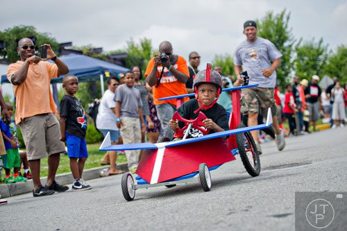 Anderson Barnes steers his car down the street during the 2nd annual Cool Dads Rock Soap Box Derby at Historic Fourth Ward Park in Atlanta on Saturday, August 2, 2014. 