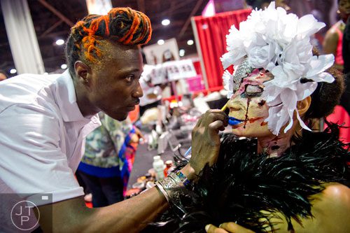 Rio Sirah (left) puts the finishing touches on Immaculate Finess' makeup during the International Bronner Bros. Hair Show at the Georgia World Congress Center in Atlanta on Saturday, August 2, 2014. 