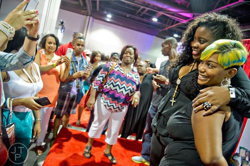 Charity Harris (right) has her photo taken with Kim Kimble during the International Bronner Bros. Hair Show at the Georgia World Congress Center in Atlanta on Saturday, August 2, 2014. 
