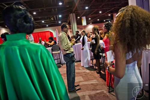 Dave Ray (center) judges models during the International Bronner Bros. Hair Show at the Georgia World Congress Center in Atlanta on Saturday, August 2, 2014. 