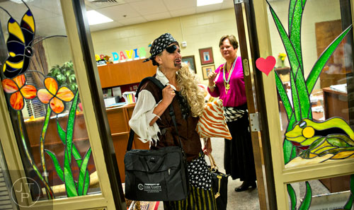 Dressed as pirates, media specialist Candy Ward (left) and principal Dr. Dee Mobley (right) wait for students to arrive for students to arrive during the first day of classes at Davis Elementary School in Marietta on Monday, August 4, 2014. 
