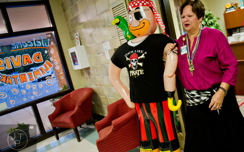 Principal Dr. Dee Mobley carries an inflatable pirate out of the office as she waits for students to arrive during the first day of classes at Davis Elementary School in Marietta on Monday, August 4, 2014. 