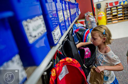 Liliana Remenih pulls her lunch out of her backpack during the first day of classes at Davis Elementary School in Marietta on Monday, August 4, 2014. 