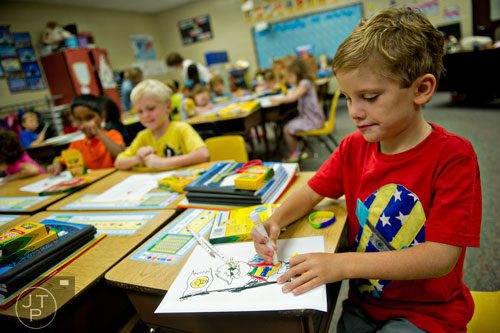 Max Psencik (right) colors a pirate worksheet during the first day of classes at Davis Elementary School in Marietta on Monday, August 4, 2014.
