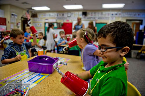 Emil Sadykhov (right) checks out his pirate hook during class at Davis Elementary School in Marietta on Monday, August 4, 2014. 