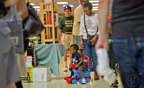 John Callaway III (center) rides a Thomas the Train car followed by his grandmother Lillie Bowles during the 47th Atlanta Model Train and Railroadiana Show and Sale at the North Atlanta Trade Center in Norcross on Saturday, August 9, 2014. 