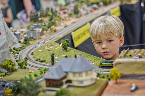 Carson Mundt watches a model train pass by during the 47th Atlanta Model Train and Railroadiana Show and Sale at the North Atlanta Trade Center in Norcross on Saturday, August 9, 2014.